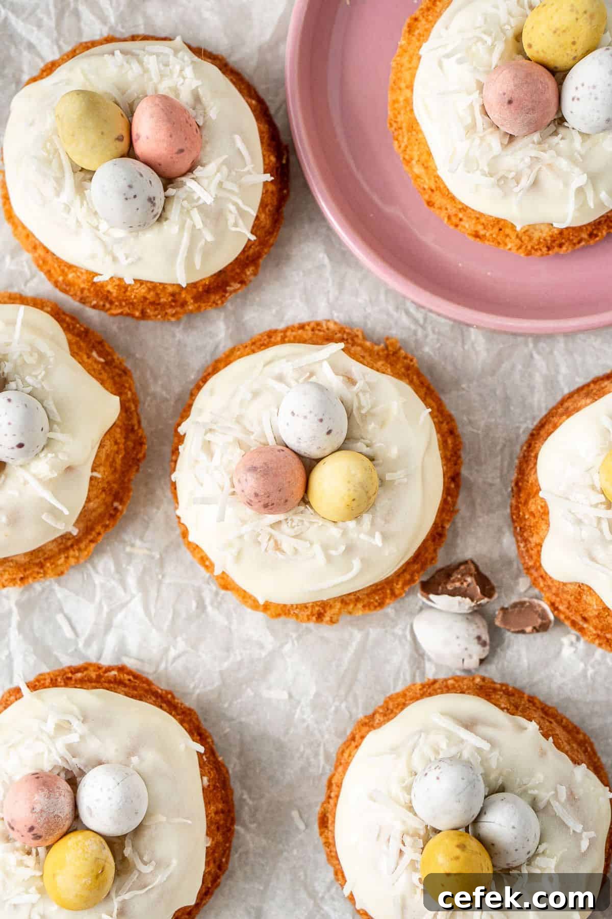 Mini Easter Bundt Cakes, topped with a cream cheese frosting, on some baking paper.