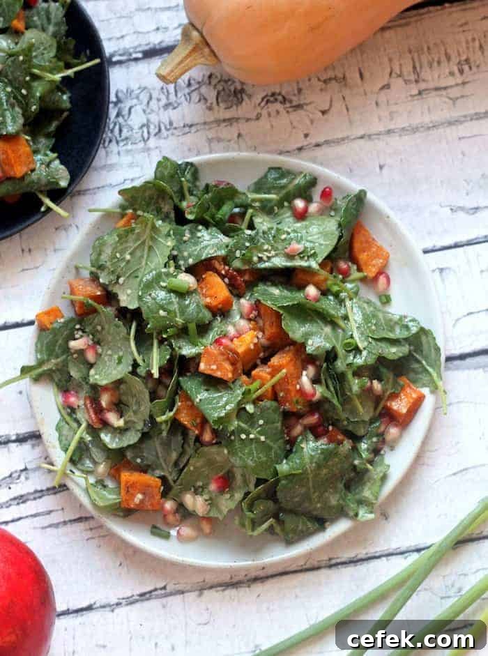 This Healthy Fall Superfood Salad is loaded with roasted butternut squash, pecans, pomegranate, and a creamy orange cinnamon vinaigrette for the perfect autumn meal.