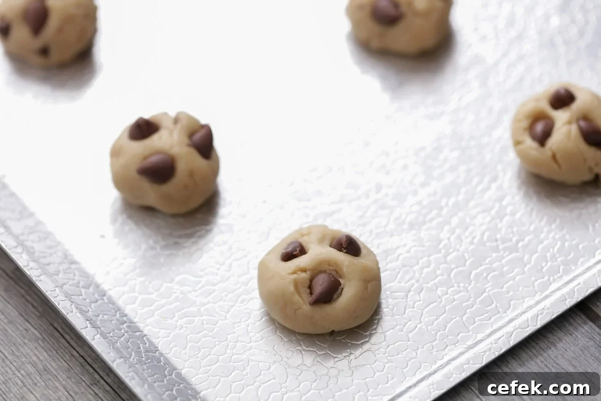 Mini cookie dough balls on a sheet pan.