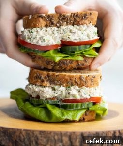 holding sandwich above another sandwich showing filling