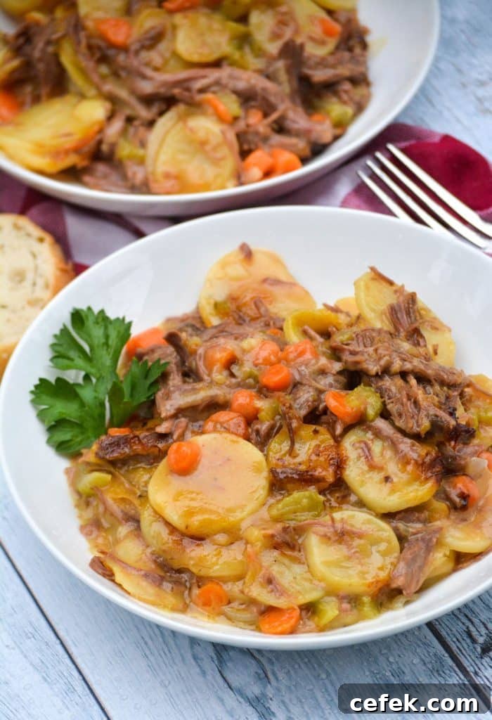 leftover pot roast casserole in two white bowls with sprigs of fresh parsley leaves on the side