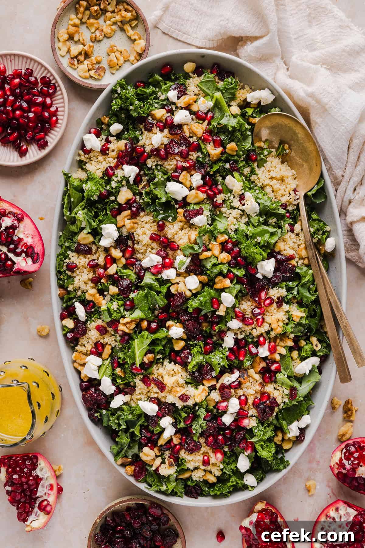 This Winter Kale and Quinoa Salad is a vibrant, wholesome salad that is bursting with flavor! Made with leafy kale, tender quinoa, juicy pomegranate seeds and crunchy walnuts all tossed together with a light dijon vinaigrette for the perfect holiday side dish!