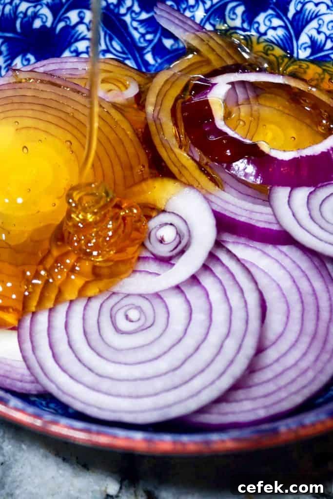 Pouring honey over onions for homemade cough syrup