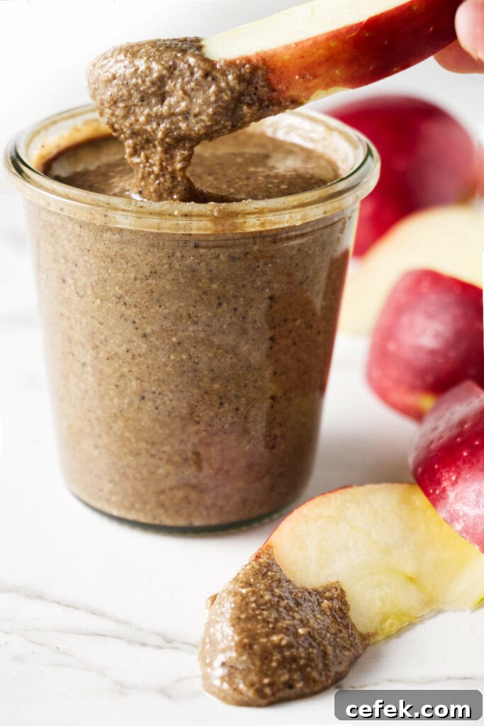 Dipping an apple slice into granola butter.
