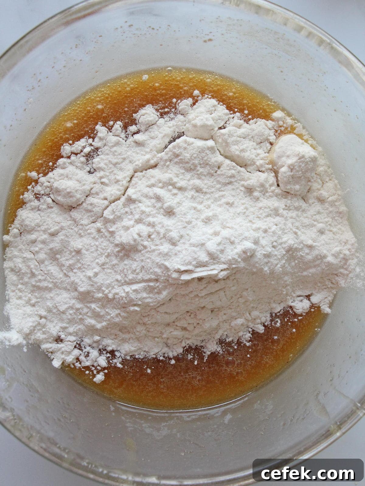 Batter for blondies in preparation inside transparent kitchen bowl