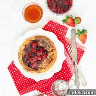 Matzo meal pancake with fruit compote on top on a red linen.