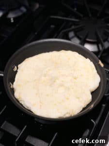 matzo meal pancake in frying pan before flipping
