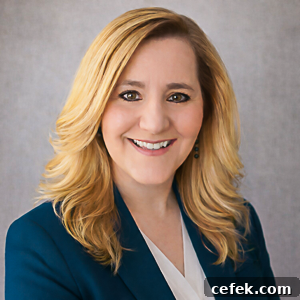 a professional portrait of zona house wearing a teal blazer.