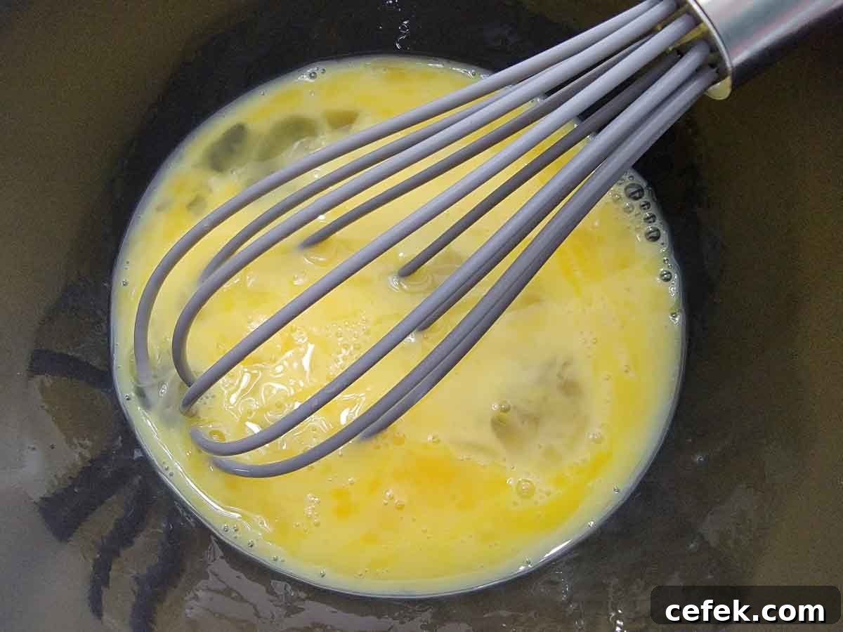 eggs whisked in a bowl.