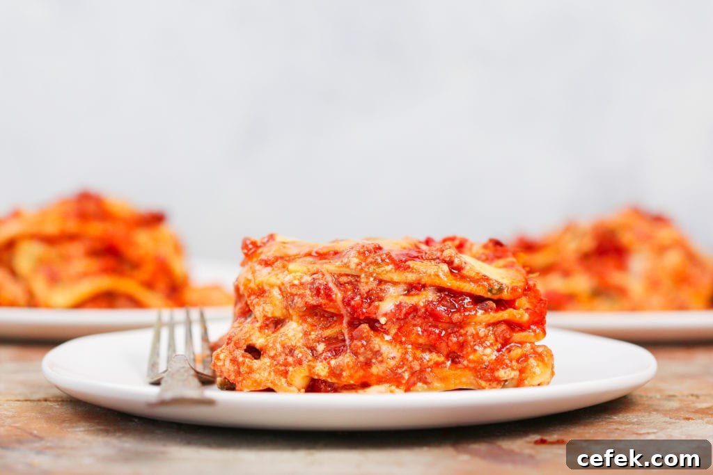 slice of lasagna on white plate.