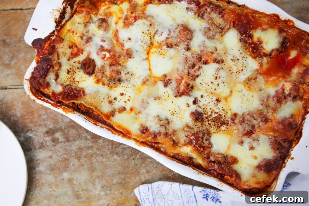 cheesy baked lasagna in white dish.