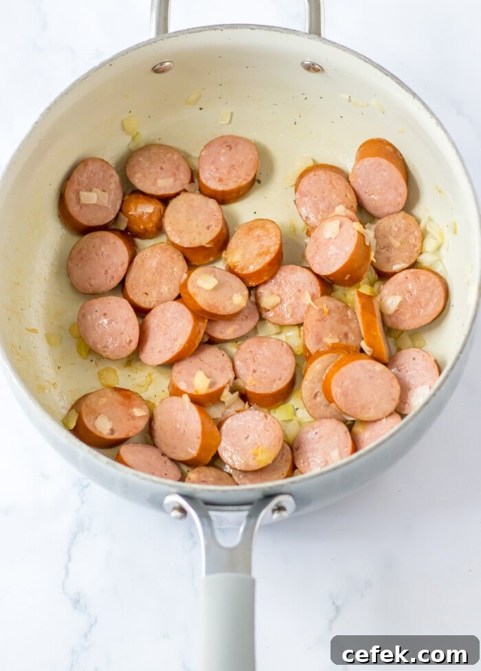 sliced sausage cooked with onion in skillet