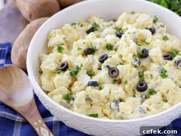 A best potato salad recipe topped with sliced olives.