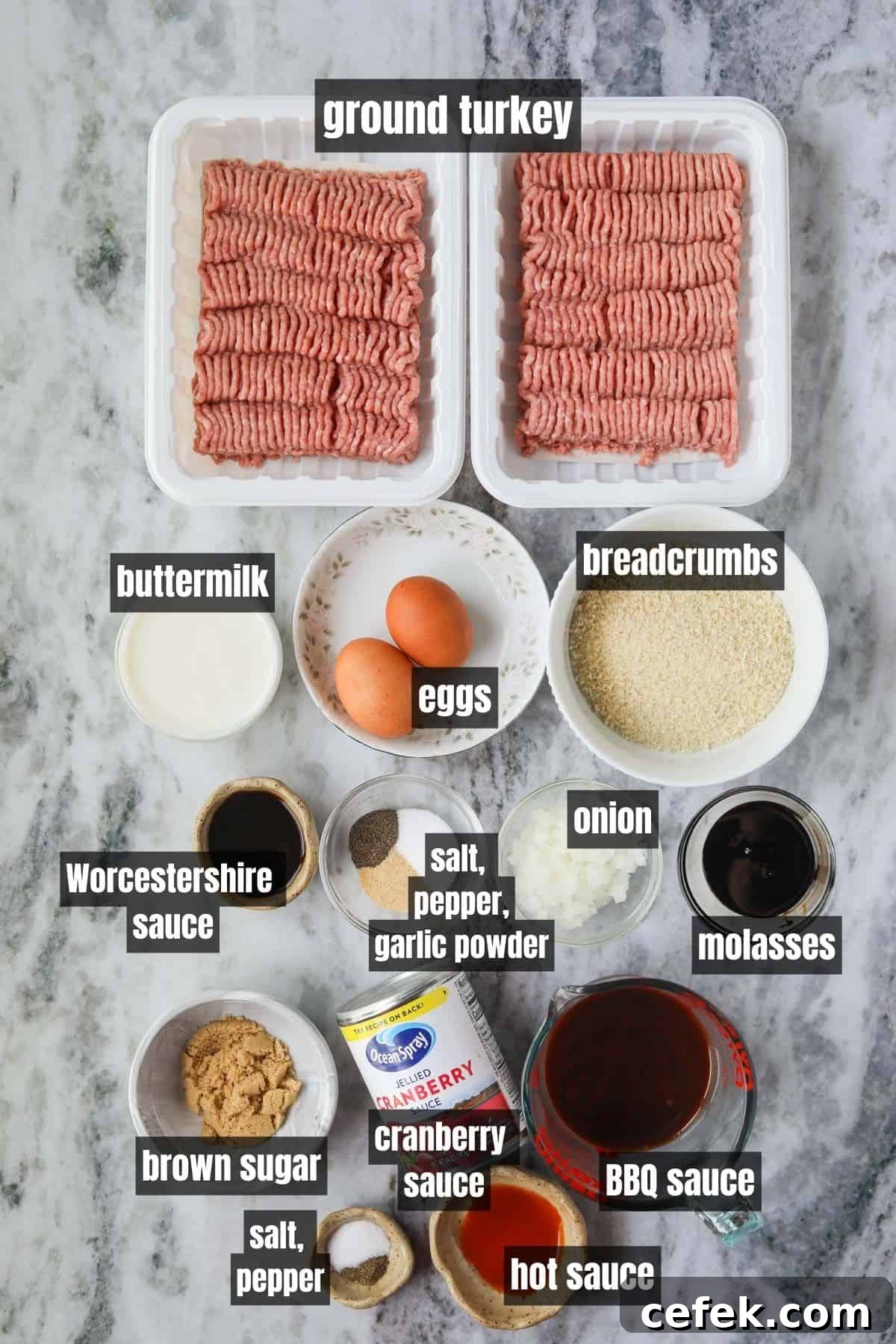 Ingredients for making cranberry meatballs arranged on a gray marble surface.