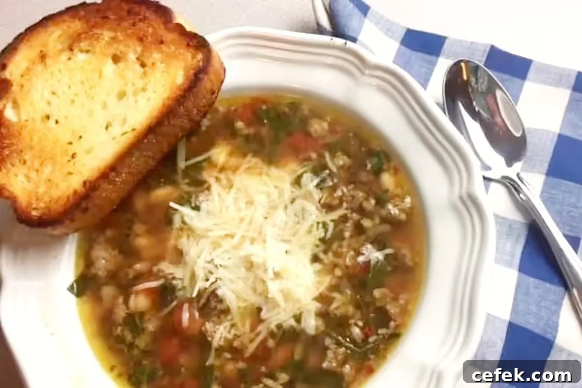 Rustic Italian sausage soup with tomatoes, spinach, and pasta in a savory broth — an easy, hearty meal for chilly nights.