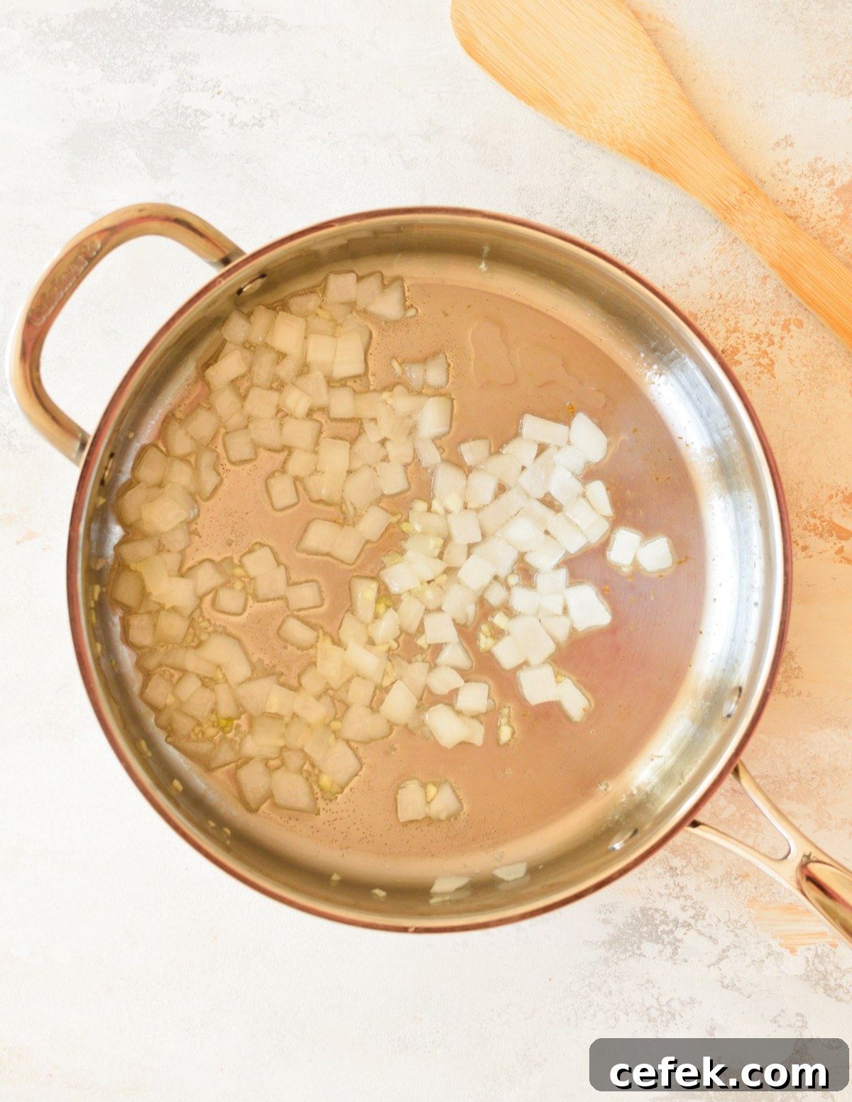 a skillet with onion and garlic in it