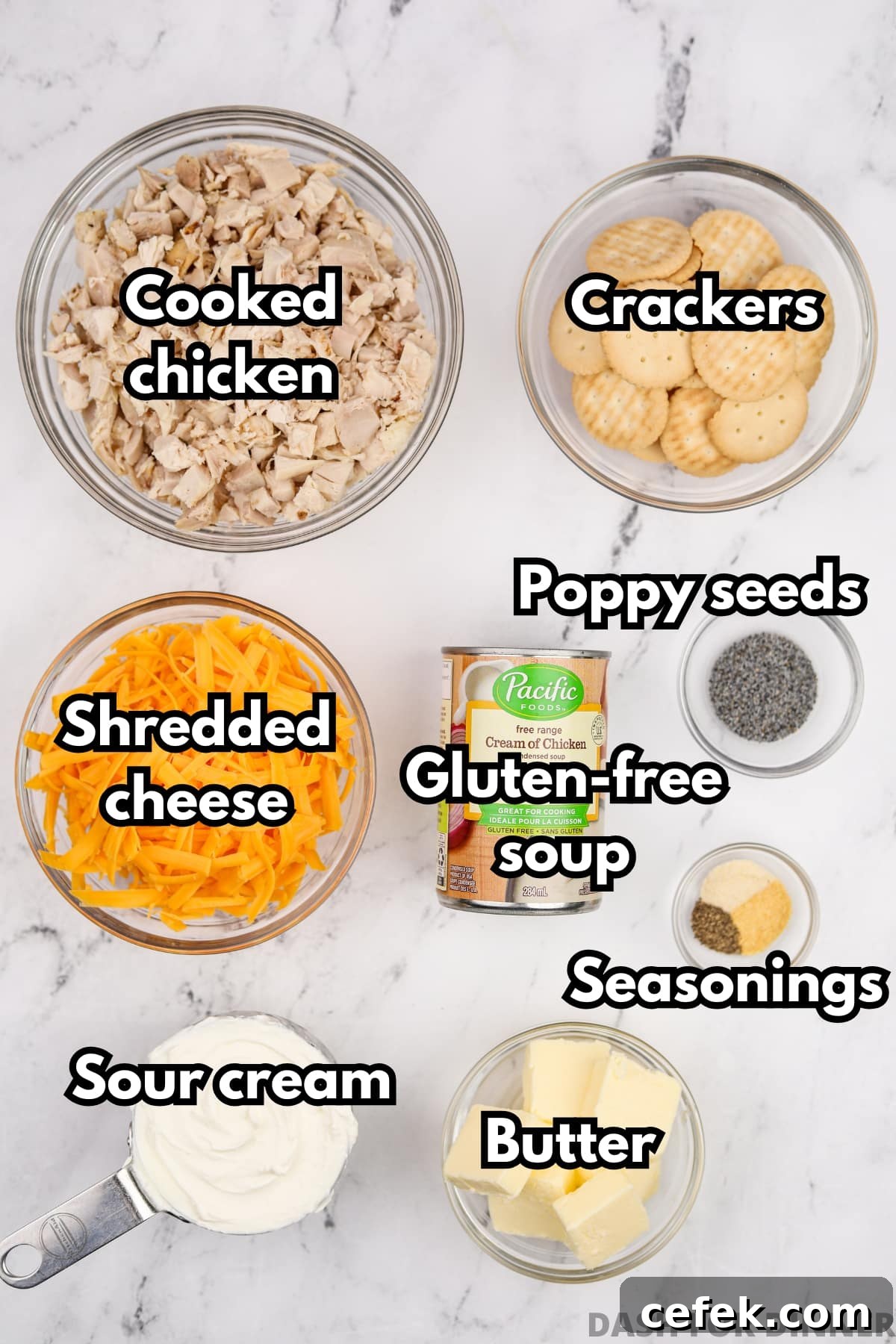 The ingredients needed to make chicken casserole, including cheese, crackers, butter, and cooked chicken.
