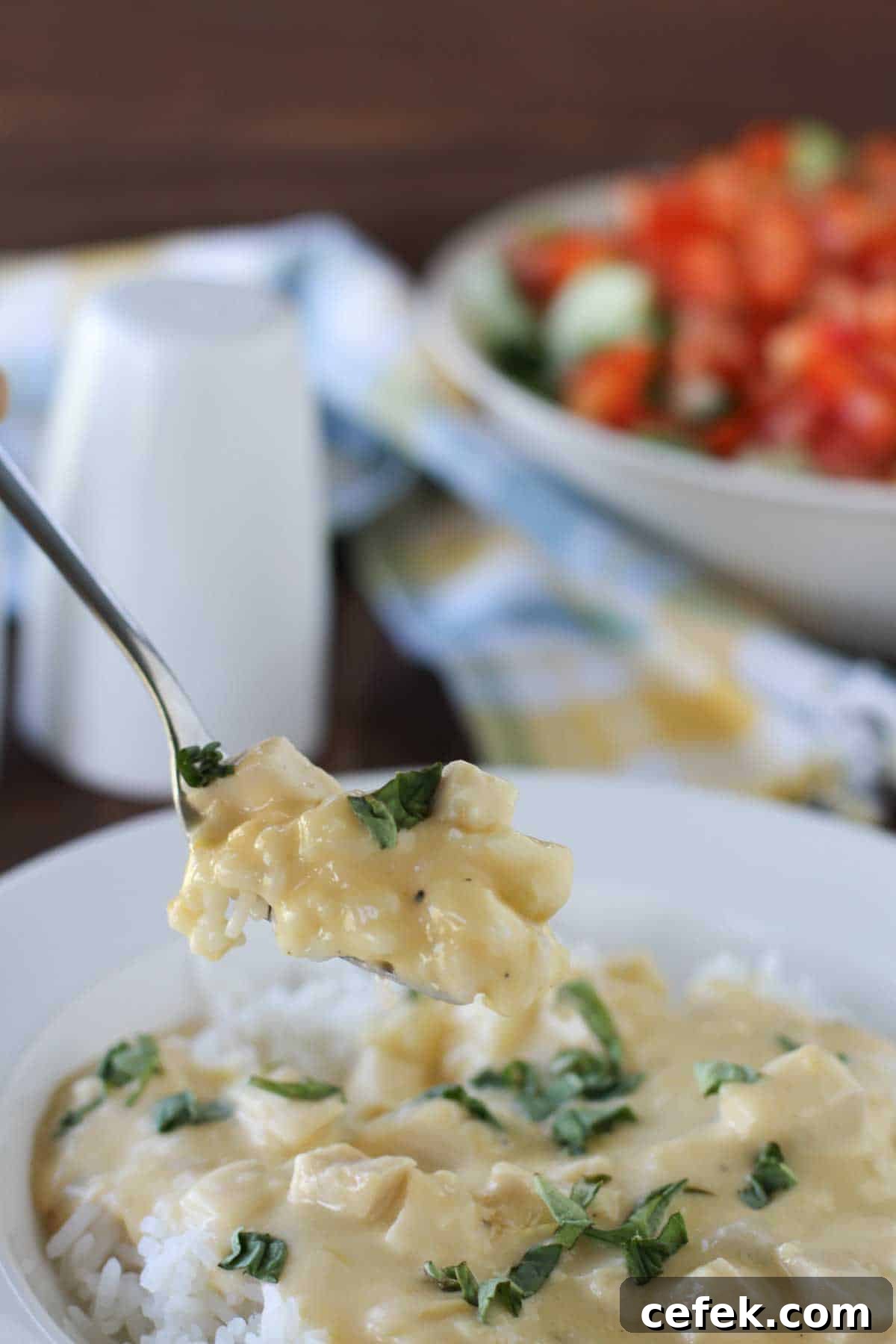 Cheesy Sour Cream Chicken with a fork taking a bite.