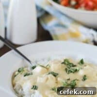 Cheesy Sour Cream Chicken served over rice and topped with basil.