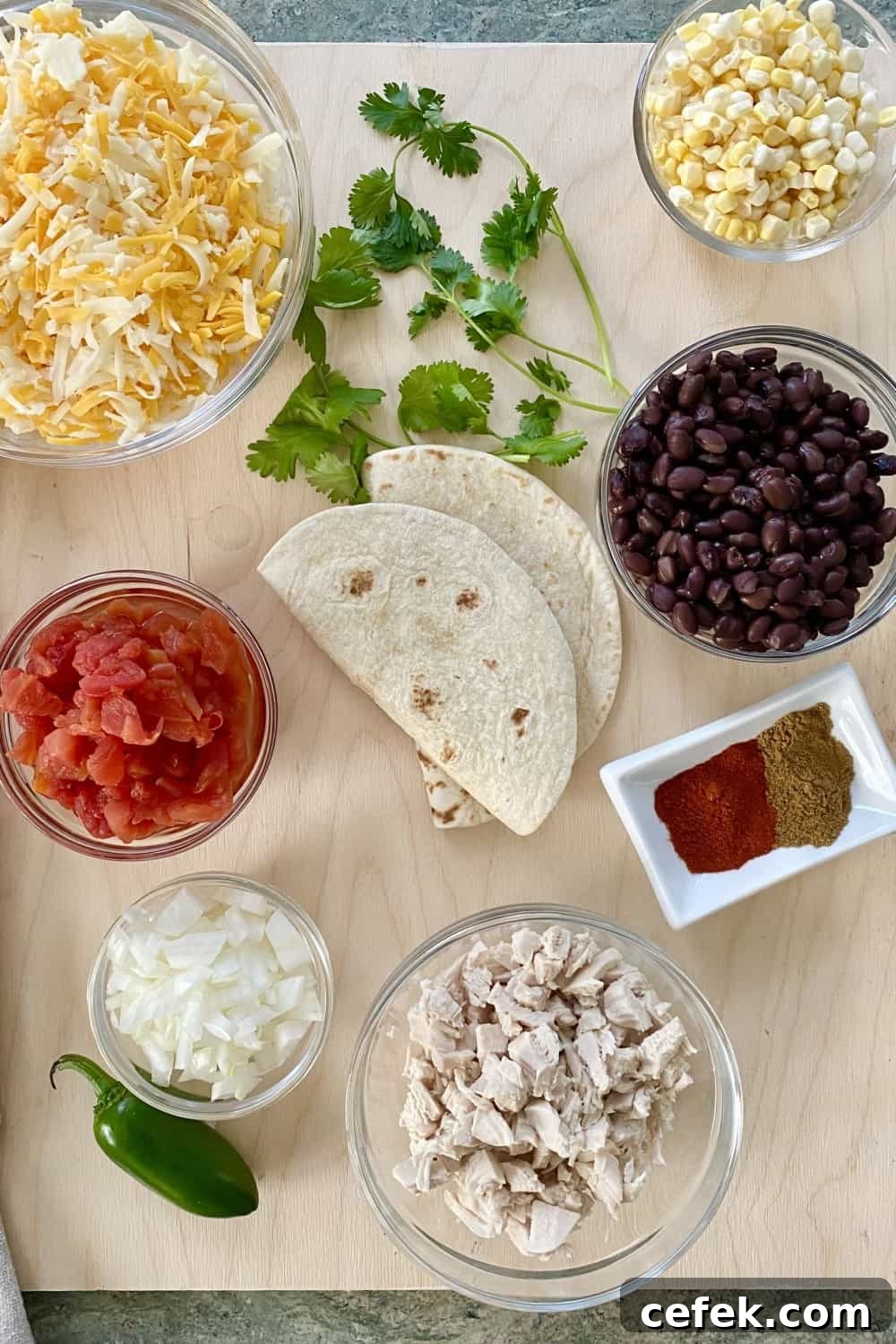 tortillas, chicken, black beans, cheese, tomato, onion, corn
