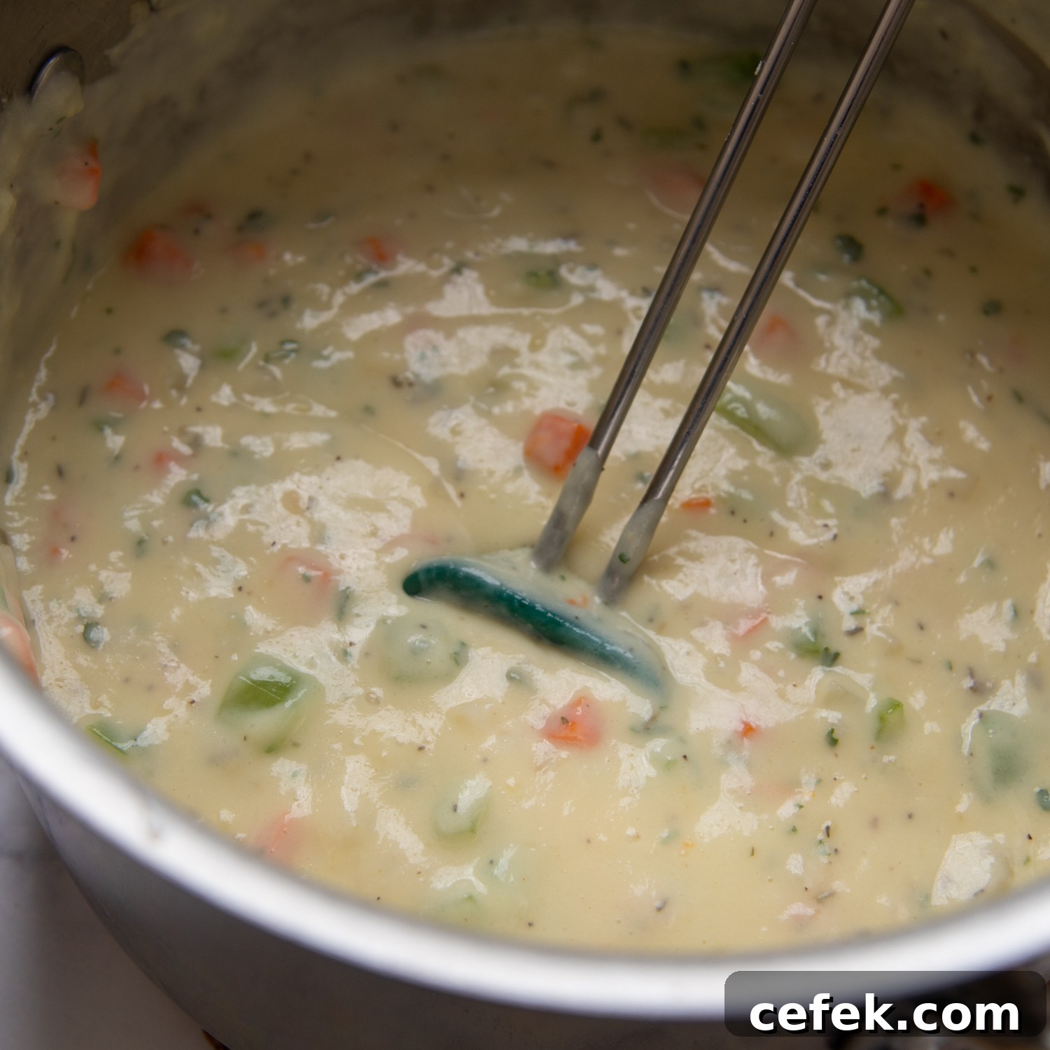the broth and milk added to the veggies to make filling.