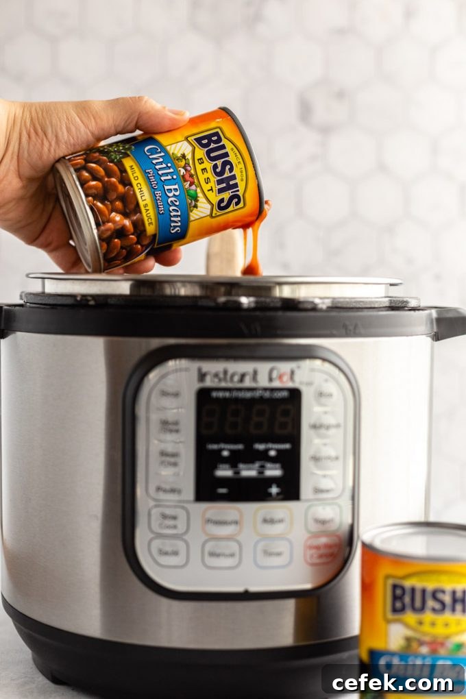 can of bush's chili pinto beans being poured into an instant pot