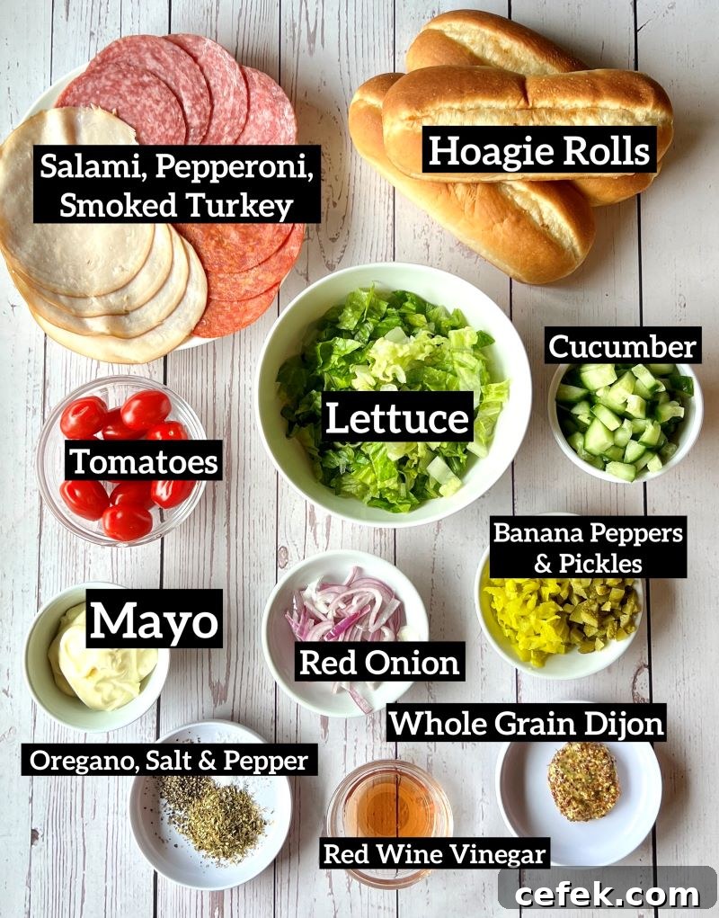 Ingredients displayed on a white board for Italian chopped salad hoagie rolls--meat, hoagie rolls, veggies, and dressing items.