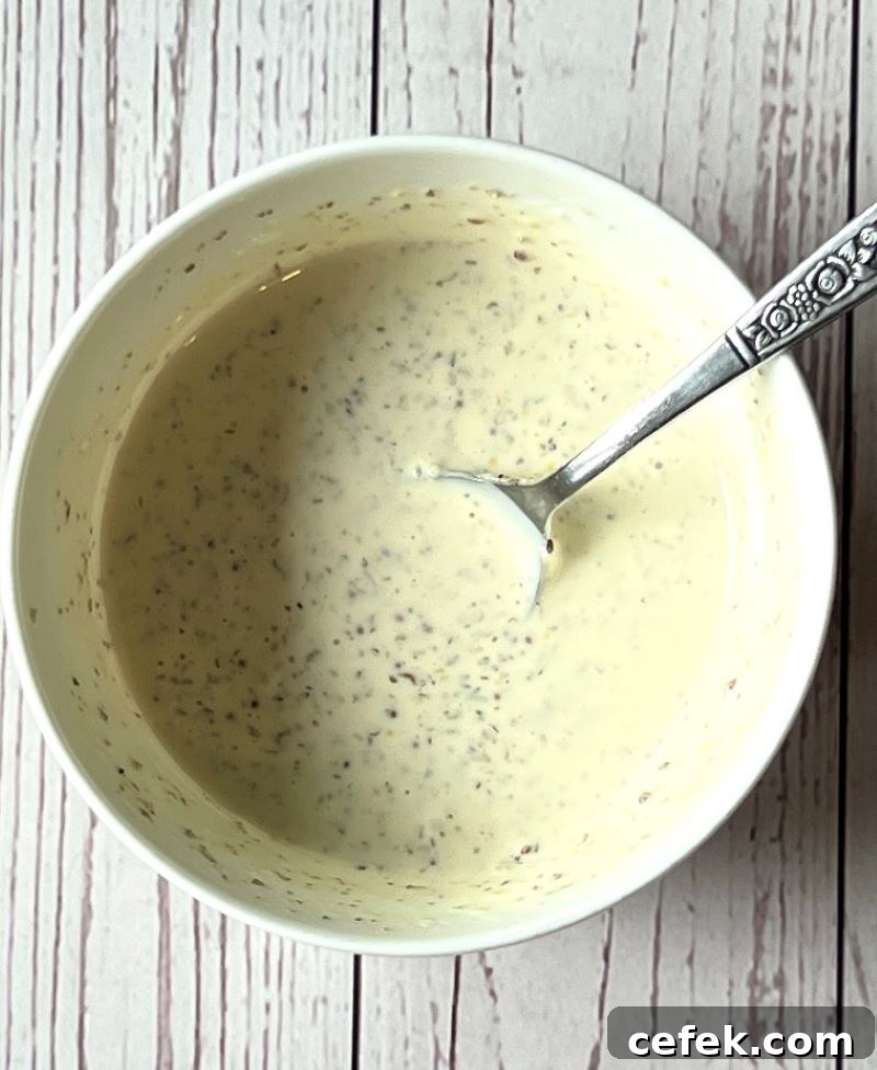 Dressing prepared in a small bowl for Italian chopped salad hoagie rolls.