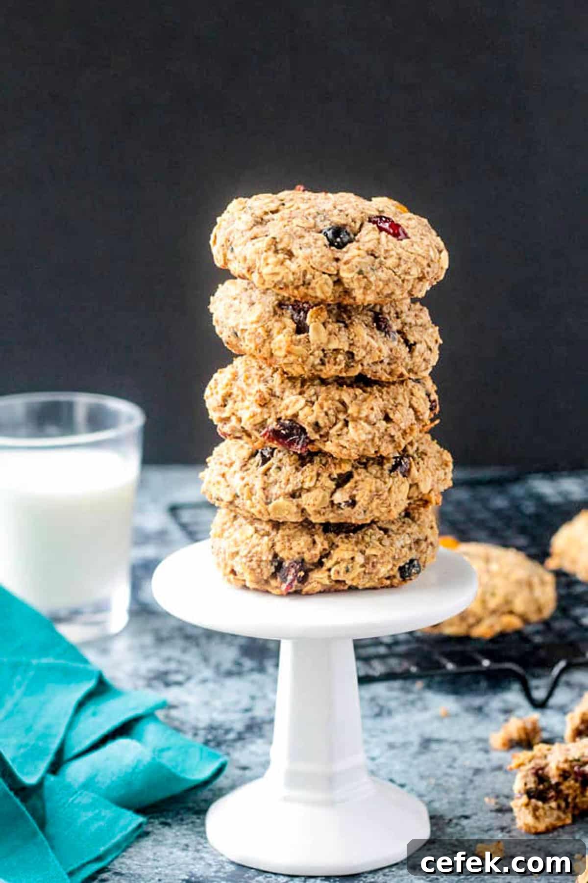 Stack of 5 oatmeal cookies on a small white cupcake stand.