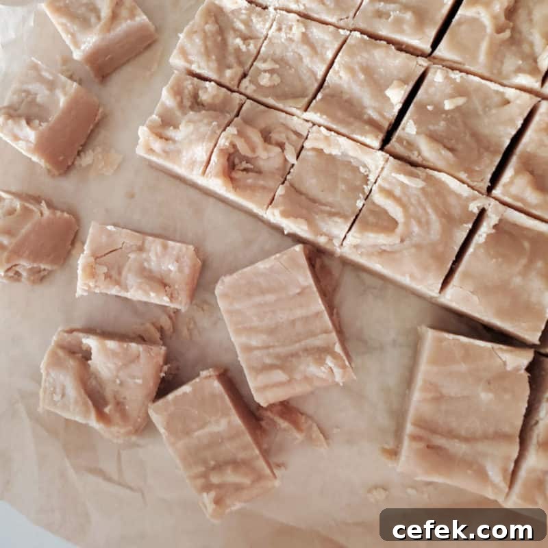 Squares of 4 Ingredient Peanut Butter Fudge on parchment paper