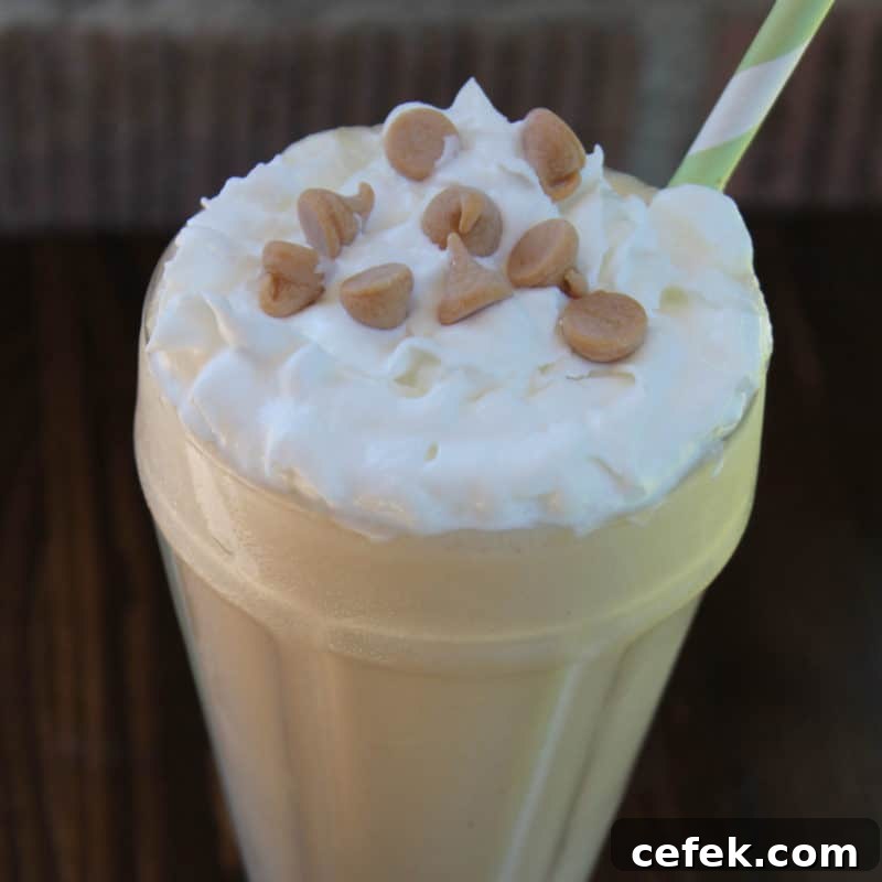 Sonic Peanut Butter Shake in a tall glass with whipped cream and peanut butter chips