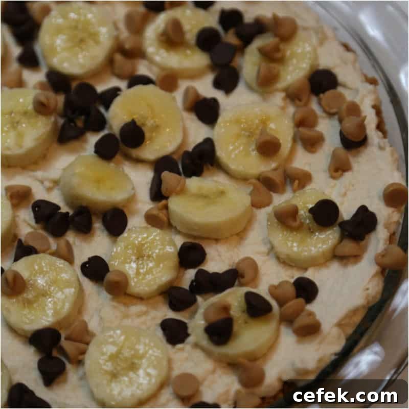 banana slices and chocolate chips on a no bake peanut butter pie