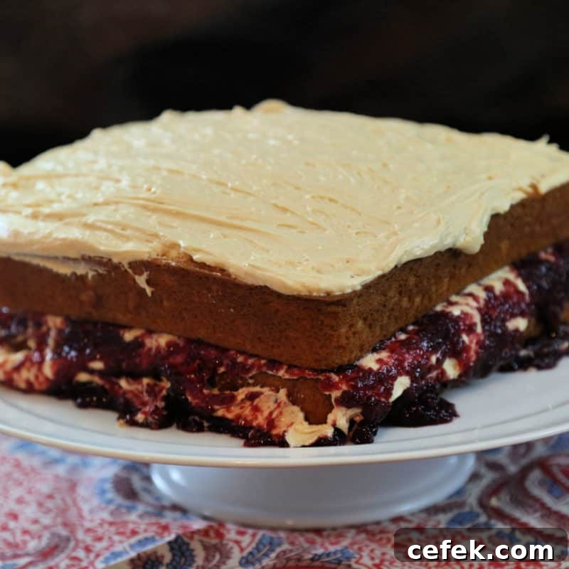 Peanut Butter and Jelly Cake on a white cake platter