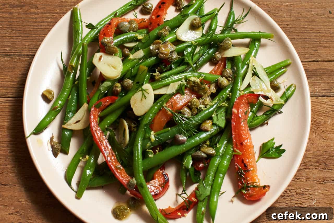 Fresh green bean salad with red peppers, capers and herbs.