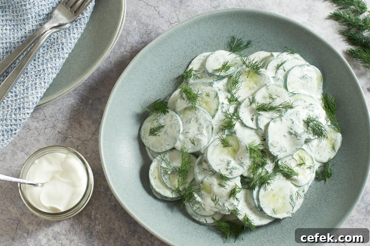 Creamy cucumber salad in a gray bowl.