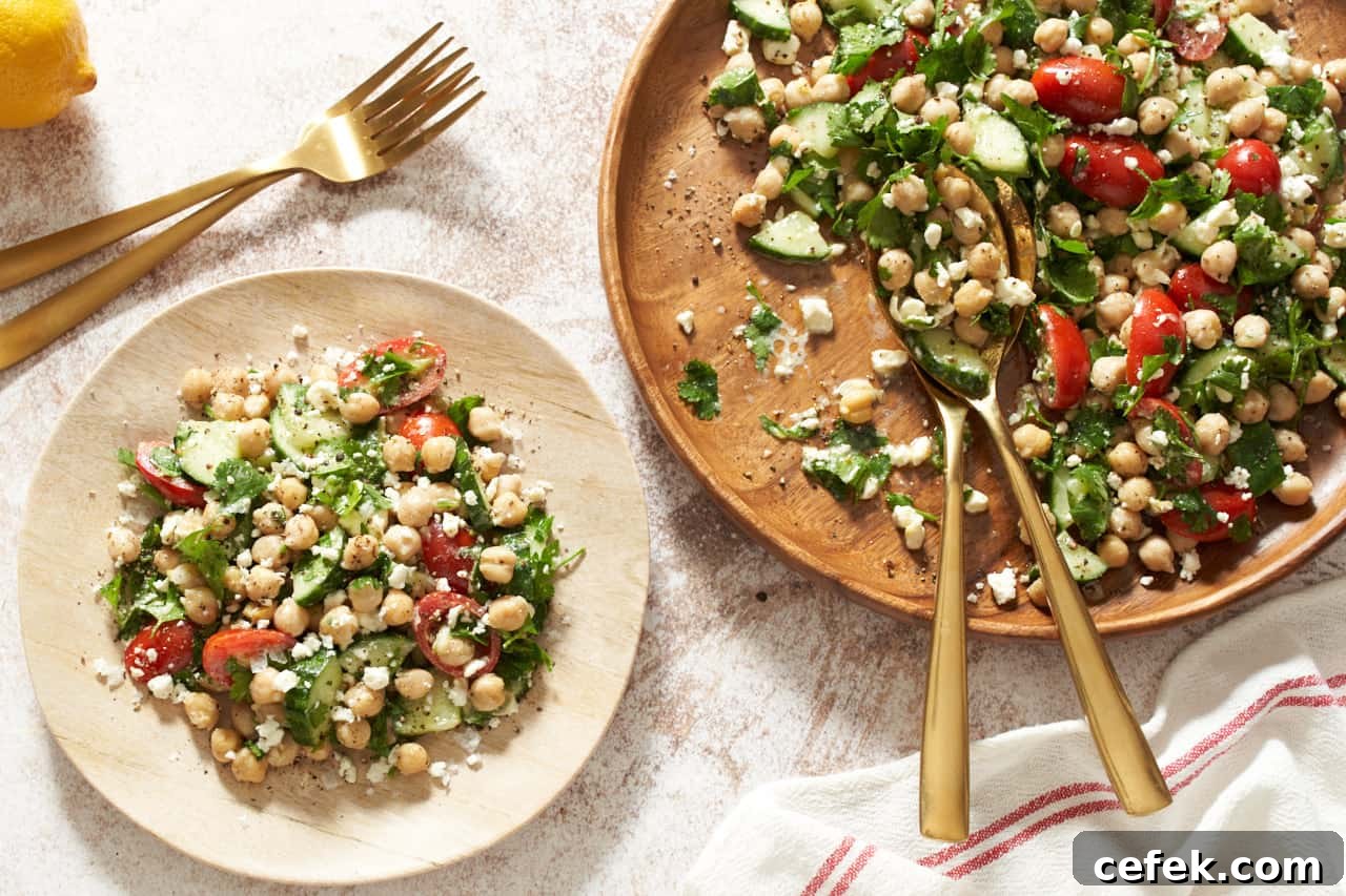 A wooden plate of garbanzo bean salad.