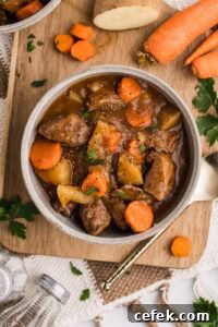 bowl of beef stew on wooden cutting board
