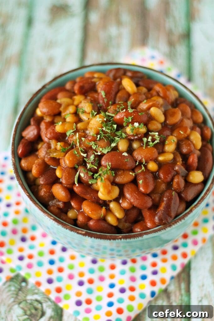 Slow Cooker Honey BBQ Baked Beans in green bowl