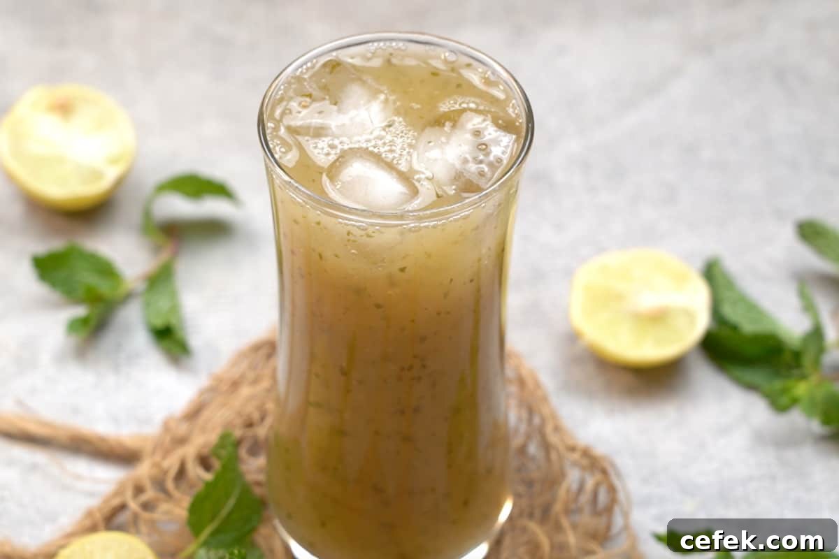 Mango panna poured over ice in a tall glass.