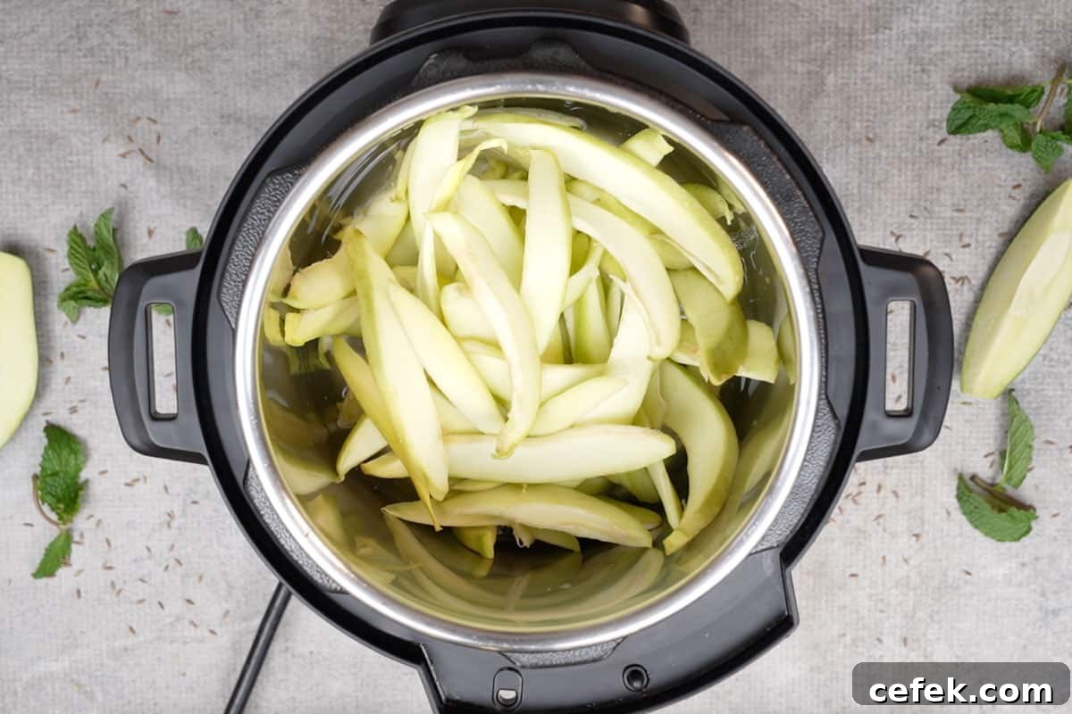 Raw mango slices and water added to instant pot.