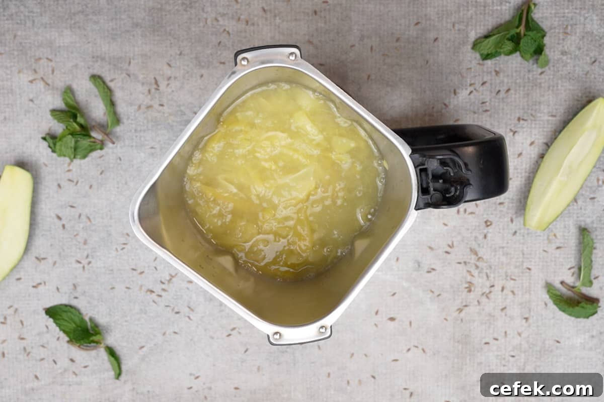 Cooked green mangoes transferred to a blender.