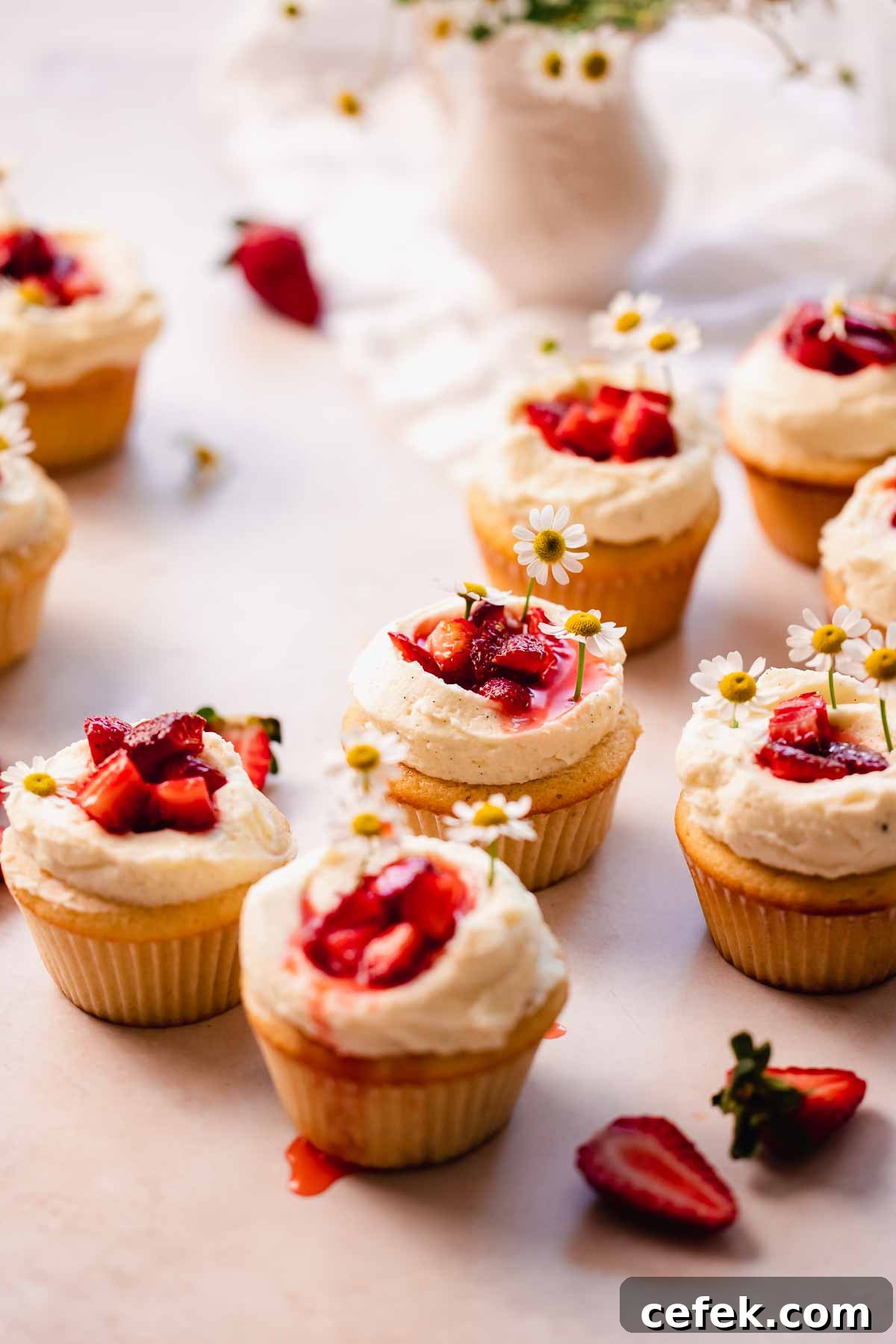 freshly made strawberry white chocolate cupcakes sitting on the table