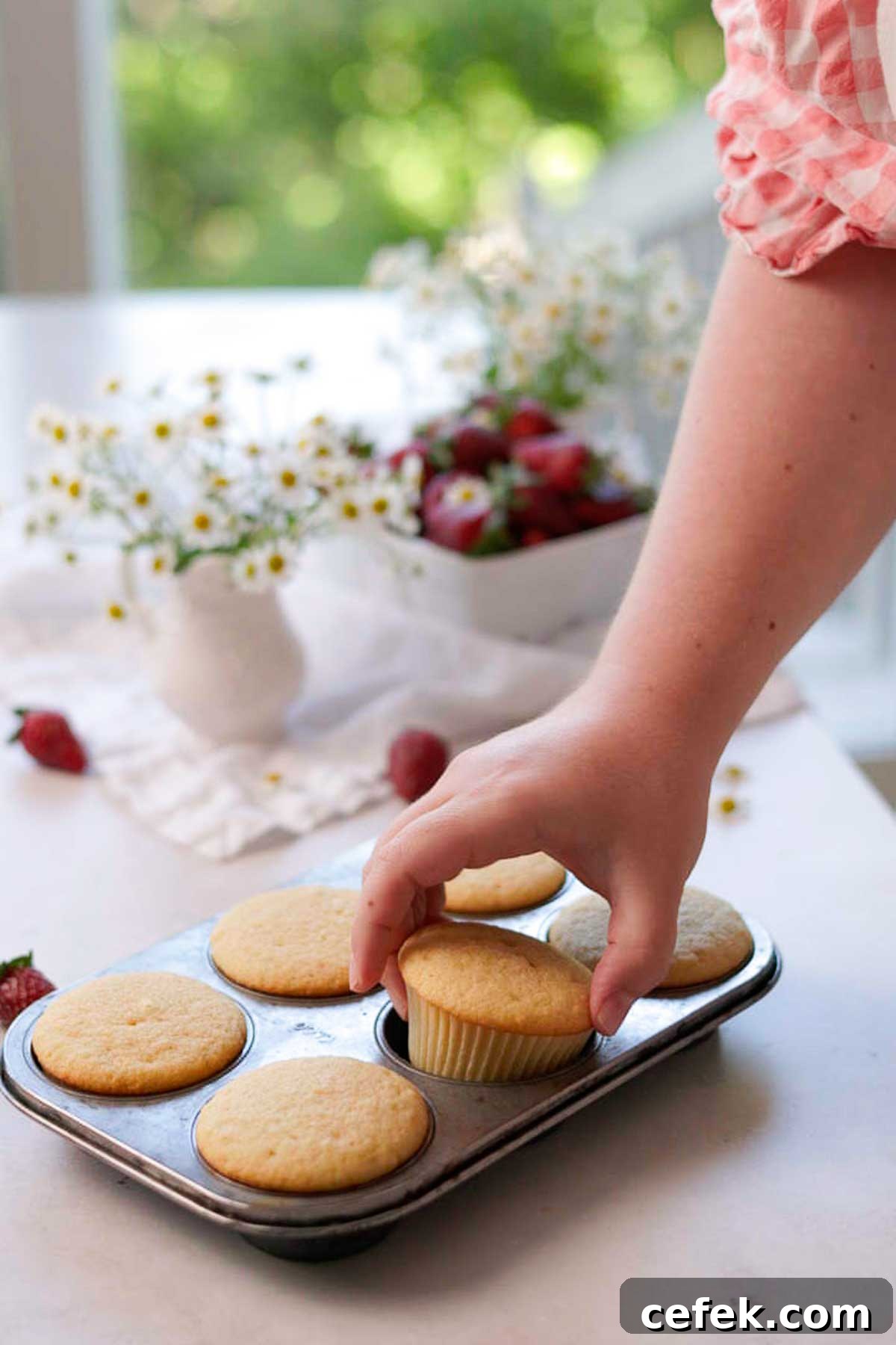 freshly baked unfrosted vanilla cupcakes in a cupcake baking tray