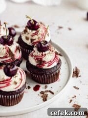 black forest cupcakes with a cherry on top on porcelain plate