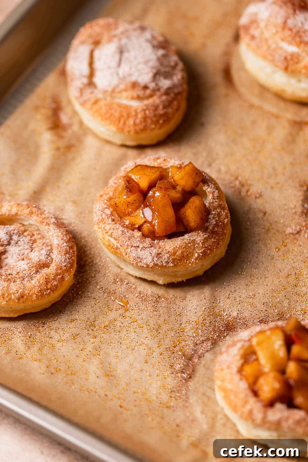 Pie filled cookies on a baking sheet after baking.
