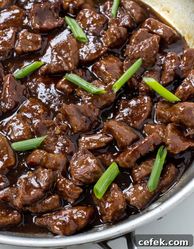 Close up shot of beef in silver skillet