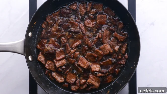 tossing flank steak in mongolian sauce