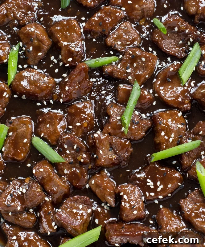 Mongolian Chinese Beef sprinkled with white and black sesame seeds and green onions
