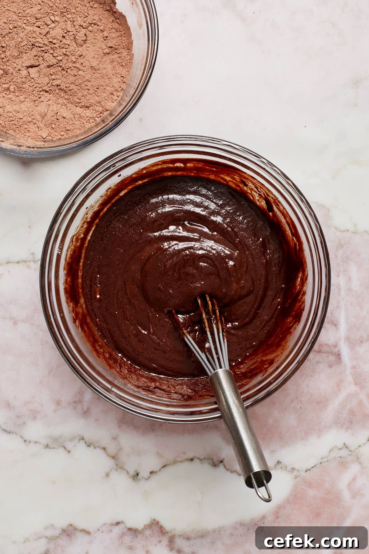 Wet ingredients whisked together in a glass bowl.