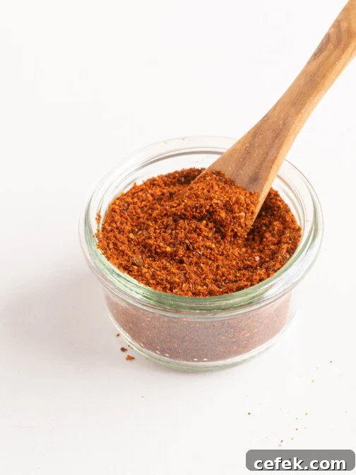 paprika in a small jar with a wooden spoon